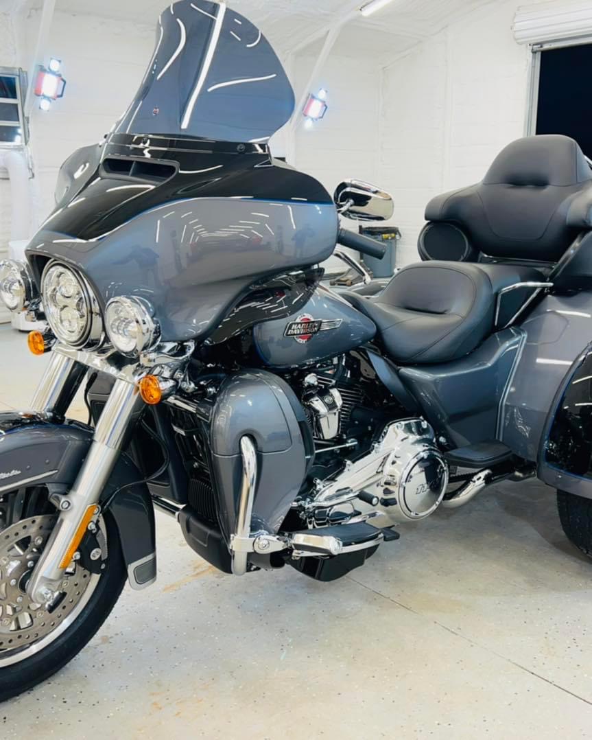 Grey Harley-Davidson Tri Glide with a mirror finish in the shop